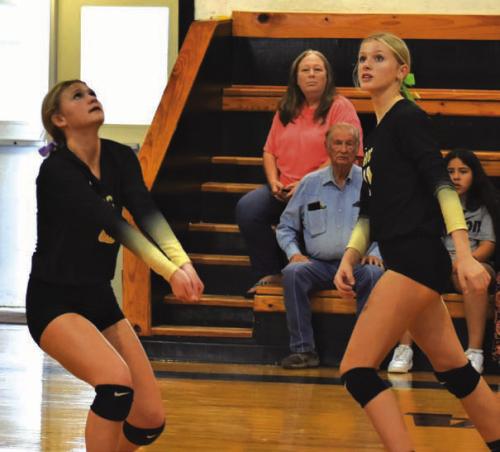 Round Top-Carmine’s Tess Eilers and Jessica Rohde await a ball in Friday’s match against Prairie Lea. Photo by Paul Kipp