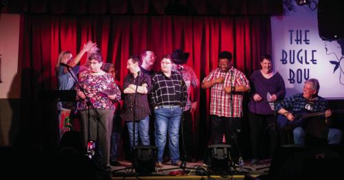 Terri Hendrix (far left) and Lloyd Maines (far right) held a songwriting workshop with a group of special needs folks from Gray Legacy Services last week. The workshop concluded with a concert at the Bugle Boy in La Grange. Photo by Andy Behlen