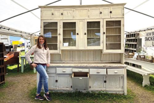 Mark Knight stands by the hutch she and her husband salvaged.