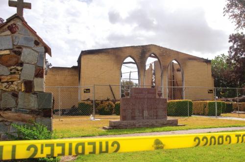 Yellow caution tape surrounded the grounds of Queen of the Holy Rosary Catholic Church in Hostyn on Wednesday, less than a week after an explosion destroyed the church building. Photo by Andy Behlen