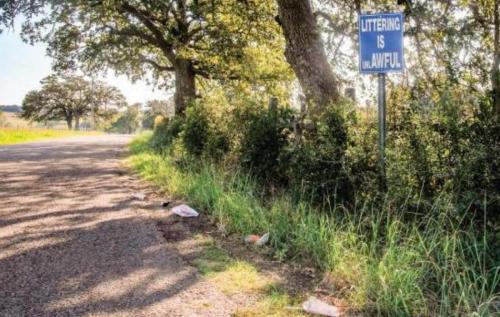 Someone recently tossed their Whataburger garbage onto the side of Rocky Creek Road in front of a littering sign. Photo by Andy Behlen
