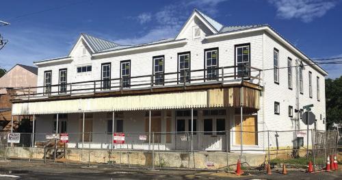 The new Fayetteville Community Center on the town square is really coming along. Above is how it looked Tuesday morning. The new building is modeled after the old Knesek building which stood on the site (below, left). The new facility uses as much of the old material from the building as they could salvage. Below, right – a show of just how far the construction has come since the slab was poured last August.