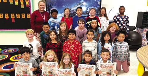 Randi Willis’ homeroom students at La Grange elementary show off the Letters to Santa magazine that included their letters as well as letters from all other second graders in Fayette County. The magazine was included in last Friday’s newspaper. Photo by Regina Keilers