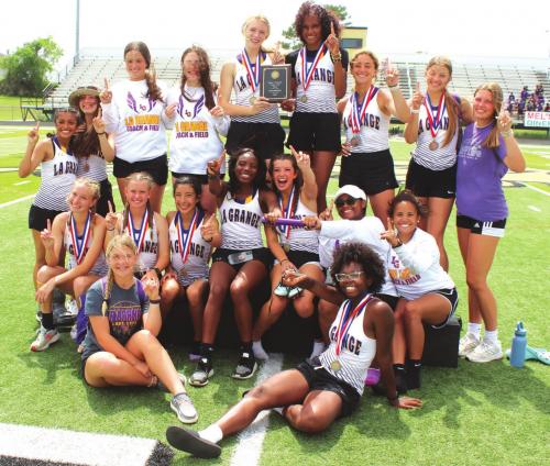 The members of the La Grange varsity girls track team show who is No. 1 as they pose with their medals and district championship team plaque after Tuesday’s running finals. Photo by Jeff Wick