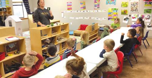 Remnant Acadamy students listen to teacher Thrina McCarty regarding the egg hatching process.