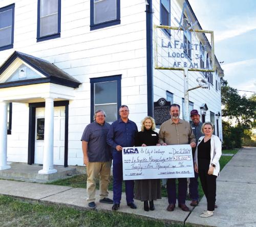 LCRA representatives present a $25,000 grant to the La Fayette Masonic Lodge #34 for improvements to historic building. The grant is part of LCRA’s Community Development Partnership Program. Pictured, from left to right, are: Jeffrey L. Messer, lodge junior warden; Scott Noles, lodge worshipful master; Margaret D. “Meg” Voelter, LCRA Board member; Jerry Meek, lodge secretary; Matthew L. “Matt” Arthur, LCRA Board member; and Kate Ramzinski, LCRA Regional Affairs representative.