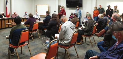 Above, a large crowd filled the Schulenburg City Council chambers on Monday, March 1. Many of the citizens who attended spoke out against the Texan Store that developers plan to build at the corner of Interstate 10 and US 77. Right, Mayor Elaine Kocian takes a moment to contemplate the deciding vote she cast in a 3-2 decision to rezone the Texan property for commercial use. Photos by Andy Behlen