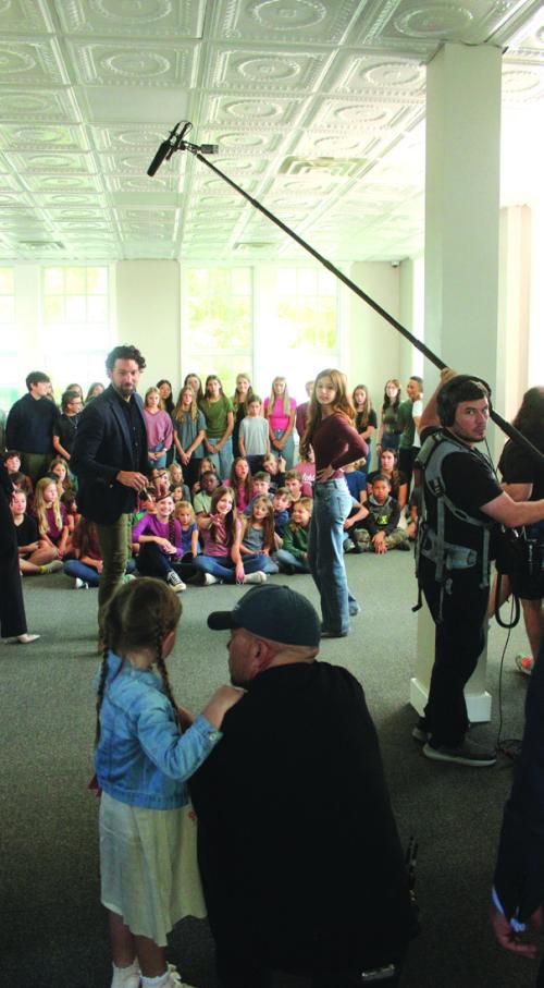 Director Shawn Welling talks to his daughter Emmarain, who stars in the movie “The Sound of Willow,” which was filming at the old red brick schoolhouse in Fayetteville last week. In the background are dozens of Fayetteville students who were used as extras in the movie. The movie also stars Lee Majors, who was one of the biggest TV stars of the 1960s, 70s, and 80s. The crew will also be filming at Festival Hill. Photo by Jeff Wick