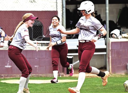 Flatonia’s Jalee Trussell celebrates her grand slam with catcher Dallyn Bishop as she crosses home plate Thursday at the Mike Schultze Softball Tournament in Flatonia. Despite Trussell’s heroics Yoakum beat Flatonia 11-6. Photo by Stephanie Steinhauser