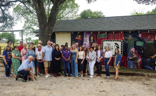 A big crowd of Bugle Boy supporters came to the live music venue Thursday morning for a mural dedication. Artist Tyler Kay recently completed the mural on the side of the building. It is the second mural she has painted in La Grange. Photo by Andy Behlen