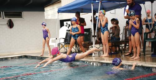 Shelby Janacek dives in on relay as Nora Kerr finished butterfly and Danni Schmidt looks on. Photo by Brittany Dawson