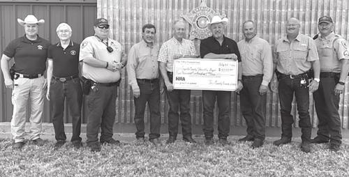 Deputies receiving the grant check are shown above, from left to right: Investigator Kenn Kretz, Charles Murray, Deputy Lee Phillips, John Salem, Dennis Brower, Sheriff Keith Korenek, Craig Schulz, Lt. David Beyer and Sgt. Ron Naumann.