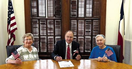 Judge Mueller signed a Proclamation designating June 14, as Flag Day in Fayette County. Witnessing Judge Mueller sign the proclamation were Helen Faldyn, and Lillian Kallus representatives from KJZT Family Life. Pictured from left are Helen Faldyn, County Judge Dan Mueller and Lillian Kallus.