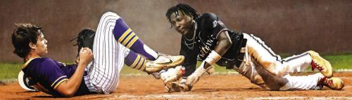Flatonia’s Keyshaun Green, right, stole home on a passed ball amidst a tangle at the plate Tuesday. But that was the only run the Bulldogs scored in what ended up being a 2-1 extra-inning loss to Shiner in a game that decided the district title. Flatonia (17-4) begin the playoffs next week as the runner-up from District 29-2A. Photo by Stephanie Steinhauser