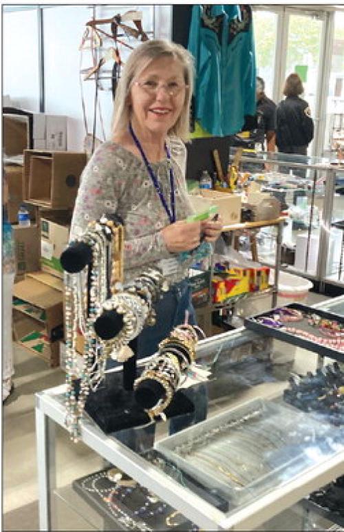 Cheri Balla, a dedicated volunteer from St. James working the bustling jewelry counter.