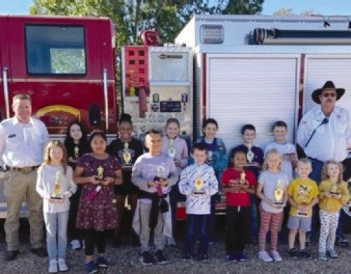 Fire prevention week poster contest winners from Round Top Carmine Elementary were: Hunter Kaspar, Clara Burkham, Collyns Schatte, Angel Lopez, Ofelia Blake Massey, Brooke McKenzie, Parker Winters, Kaelyn Platas, Bowen Williams, Gael Mendoza, Eva Boradbent, Kooper Kirts, Summer Dooley, Morgan Williams, Halle Phoenix, and Ximena Mendez. Trophies were presented by Round Top – Warrenton V.F.D. President/Asst. Chief Calvin Krause and Capt. / Training Officer Keith Burcalow.
