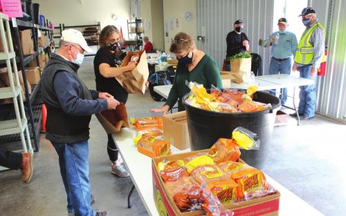 AMEN Food pantry volunteers wrap up some final chores after a morning full of distributing food last Monday in La Grange. Photo by Jeff Wick