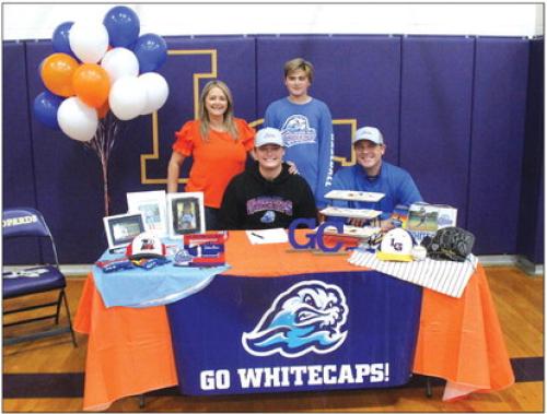 La Grange ace senior pitcher Trenton Barnes signed a scholarship agreement Friday to play for Galveston College after graduation. He is shown here at his signing ceremony seated, center, with his dad Bret beside him. Standing are Trenton’s mom Sarah and brother Korbin. Photo by Jeff Wick