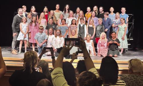 The La Grange elementary school honor choir held their public performance last Tuesday at the Performing Arts Center. Here the choir and director Phillip Brummett pose for pictures after the show. Photo by Chrystal Wick