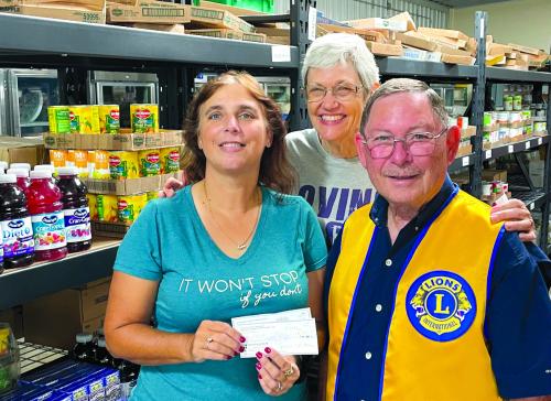 The La Grange Noon Lions Club recently gathered donations from the Lee County Sheriff’s Office, the Fayette County Sheriff’s Office, members of the Noon Club and matching funds from the La Grange Lions Foundation for the AMEN Food Pantry. Lion Treasurer Chuck Gibson is shown presenting donations totaling $2,200 to Cassie Girard and Susan Schultz of AMEN.