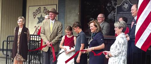 Diane Mikesky and Nina Howard of the Schulenburg Chamber of Commerce assisted Katrina Elvig’s grandchildren, Jaxson and Josie Packard, in cutting the ribbon at the ceremony to unveil a historical marker from the Texas Historical Commission on the Breymann Building.