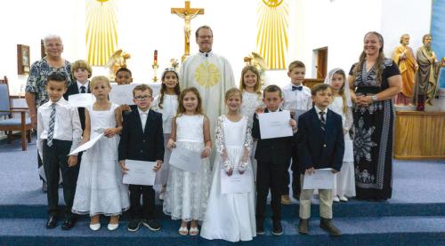 The Plum, Hostyn First Communion was held on Sunday, May 11. Pictured back from left: Teacher Monica Muras, Wyatt Wischnewsky, Bryan Toro, Abigail Acosta Reyes, Father Eddie Winkler, Ruth Brugger, Jaxon Hromadka, Faith Kimball, Teacher Brianne Bernsen; front row: Roman Veitch, Allie Zbranek, Jordy Zaruba, Shelby Janacek, Quinn Hatfield, Lucas Gommert, and Barrett Bernsen. Photo by Colton Brugger