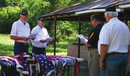 Adjutant Bruce Bockhorn presents the flags for inspection to 1st Vice Commander Marvin Wessels and Financial Officer Frank Williams as Post Commander Lyn Reavis looks on.