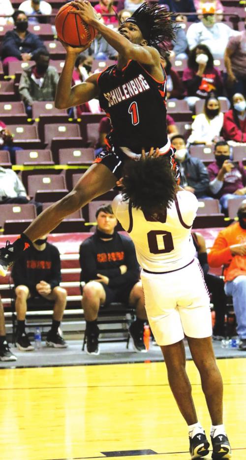 Schulenburg’s Kenny King looks as if he could hurdle over this Grapeland defender on this play Tuesday. Photo by Audrey Kristynik
