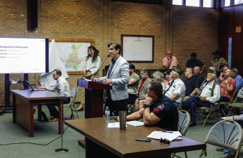 Chris Casey with the consulting firm Parkhill addressed the La Grange City Council Monday evening about proposed improvements to City Hall, the police station and Randolph Recreation Center. A big crowd filled the Council Chamber for the meeting. Some were there representing groups that use the Fayette County Fairgrounds, as the City has embarked on a master plan for future development at the Fairgrounds. Others were there to voice concerns about City spending. Photo by Andy Behlen