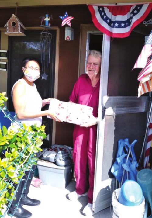 La Grange Site Manager Keisha Sanders delivering meals and gifts to county resident.