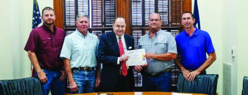 The Fayette County Commissioners Court signed a certificate of appreciation honoring Pct. 2 Commissioner Luke Sternadel for his 42 years of service to the County. Pictured are (from left) Pct. 4 Commissioner Drew Brossmann, Pct. 3 Commissioner Harvey Berckenhoff, County Judge Dan Mueller, Sternadel, and Pct. 1 Commissioner Jason McBroom. Photo by Andy Behlen