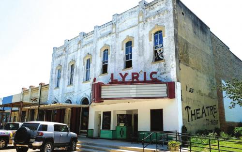A picture of silent movie star Charlie Chaplin hangs in the window above the Lyric Theater marquee. Artists and couple Terry Ehler and John Knotts purchased the building in downtown Flatonia last Friday. Photos by Andy Behlen