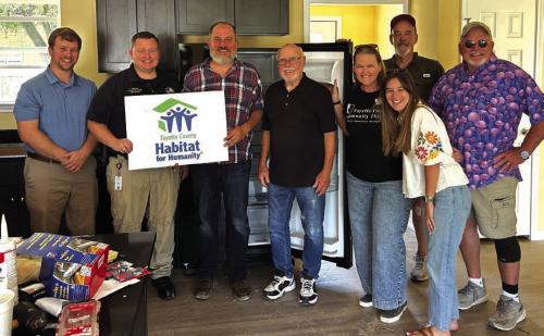The Rotary Club of La Grange donated the funds to purchase the refrigerator, microwave, range/ oven and washer/dryer for the newest Habitat for Humanity home. Pictured here are Rotary members Kyle Hartmann, President Elect-Josh Vandever, Kenny Couch, La Grange Habitat for Humanity CEO, Mike Coppinger, Heather Barthelme, Ashleigh Parks, Randy Albers, and Rob Muil.