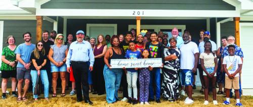 Johnny Wright, surrounded by his family and volunteers from Habitat for Humanity, got the keys to his new house in La Grange’s Hope Hill neighborhood during a home-blessing ceremony on Friday, May 30. Photo by Andy Behlen