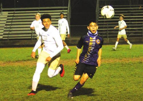 La Grange’s Johnny Vazquez races a Rockdale player to the ball in district soccer action Friday night at Leopard Stadium. Photo by Jeff Wick