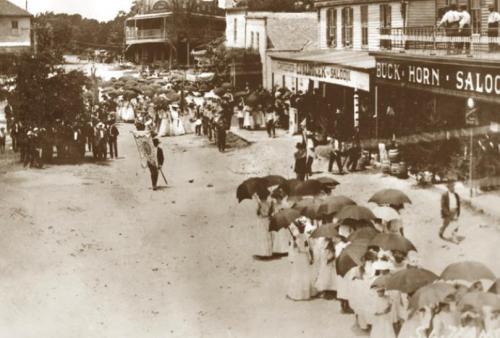 A parade in downtown Fayetteville in 1905, showing the Knesek building on the right.