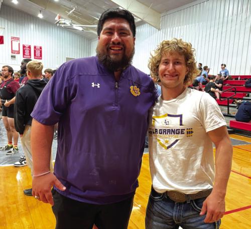 La Grange powerlifting coach Carlos Guevara, celebrates with Cody Krupala as they learned he was headed to the state meet in powerlifting.