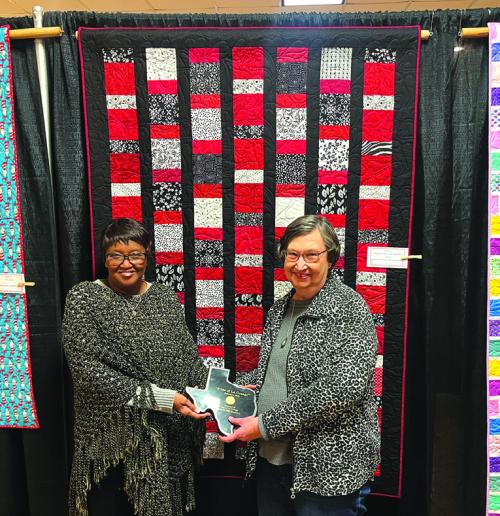 A quilt by Barbara Schellberg of La Grange called “Black, White and Red All Over” was chosen as The Pride of La Grange winner in the artisan category at this year’s Best Little Quilt Show in Texas. Schellberg is shown here, right, accepting the award from La Grange mayor Jan Dockery, left. Photos by Jeff Wick