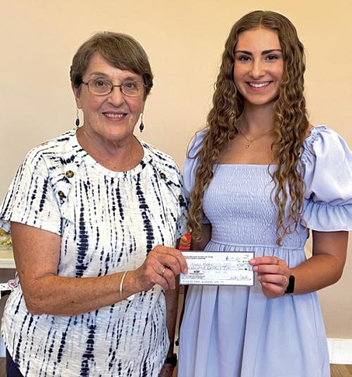 Carolyn Heinsohn presenting Sadie Noska the CHS Scholarship check.