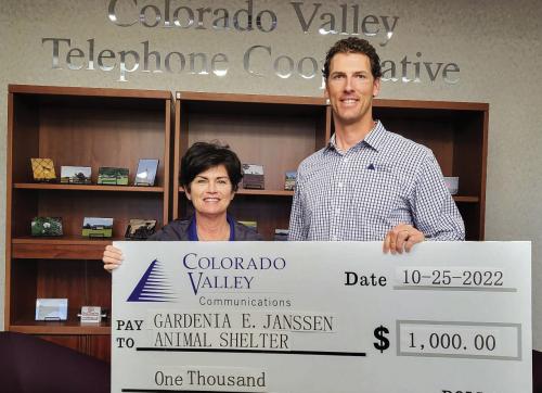 Members of Colorado Valley Telephone Cooperative contributed donations to be presented to the Gardenia E. Janssen Animal Shelter. Pictured from left to right are: Teresa Stanley-Brown, Director of the Gardenia E. Janssen Animal Shelter and Kenn Kasparek, Sales &amp; Marketing Coordinator at Colorado Valley Telephone Cooperative.