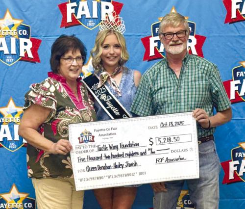 Phyllis Fritsch, Fayette County Fair Queen Hailey Janish and Fayette County Fair Association President Michael Zuhn.