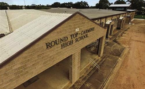 The front of Round Top-Carmine High School. They have a gym from the 1940s and no track.