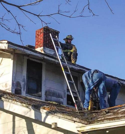 Schulenburg firefighters climbed on a roof to put out a chimney fire on Thursday, March 31. Photo by Schulenburg VFD