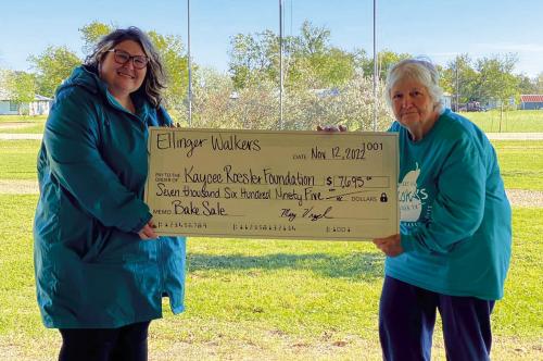 The Ellinger Walkers represented by Mary Vrazel (right) presented Kaycee Roesler (left) of the Kaycee Roesler Foundation a donation in the amount of $7,695. Funds were raised from a bake sale held by the Ellinger Walkers in April and on Saturday, November 12. A portion of the proceeds will go to a local scholarship and the remainder will be used to help pay for medical expenses. Kaycee was diagnosed with Multiple Myeloma, a rare blood cancer within the plasma cells.