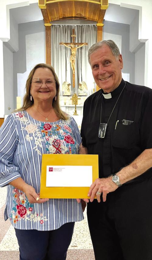 Rosanne Gallia and St. Rose of Lima Catholic Church Pastor Father Jasper Liggio.