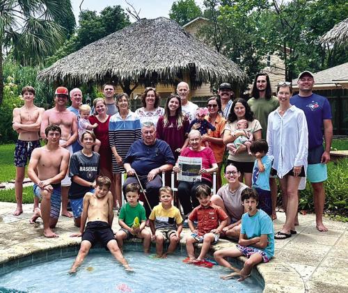 For the 27th consecutive year, members of the Leo and Barbara Wick family of La Grange descended on the Texas coast for a beach trip. When not fishing or playing dominos, volleyball or bananagrams, they enjoyed reading The Fayette County Record, held here by Barbara Wick. Shown above are 29 of the 33 attendees who all, somehow, crammed into one massive property near Dickinson. Photo by Chrystal Wick