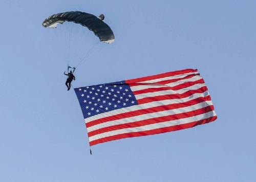 Parachutist David Moore of the Texas Skydiving team descended with a 1,000 sq. ft. American flag Friday before landing at Frisch Auf! Golf Course in La Grange, part of the a slew of local activities over the weekend, that all celebrated America’s 250th Birthday. Lots more in Section B today. Photo by Andy Behlen