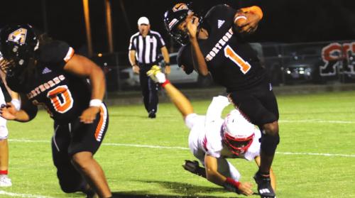 Schulenburg’s Kenny King shows off some real flexibility to get away from this St. Paul tackler. Photo by Audrey Kristynik
