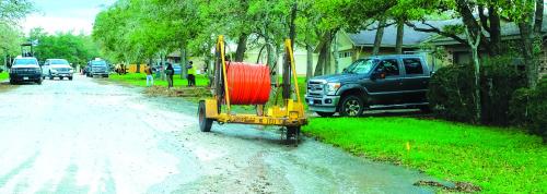 A small river of water runs down Molly Rd. in the Bluff Haven neighborhood Wednesday morning after a boring crew struck a water line near the intersection of Richard Rd. Photo by Andy Behlen