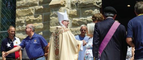 Bishop Brendan Cahill greets the faithful after mass in Praha on Tuesday.